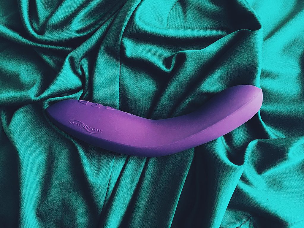 photo of purple we-vibe rave on its side on green cloth