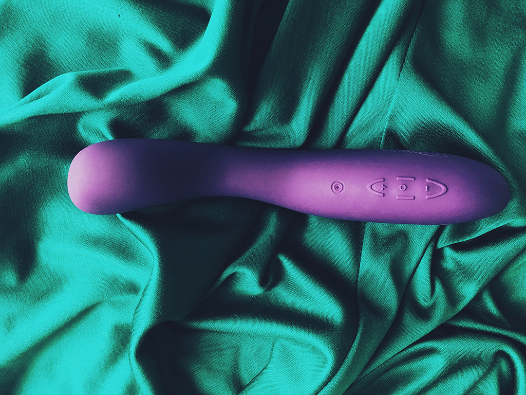 Photo of purple we-vibe rave vibrator from the top showing charging port and power controls