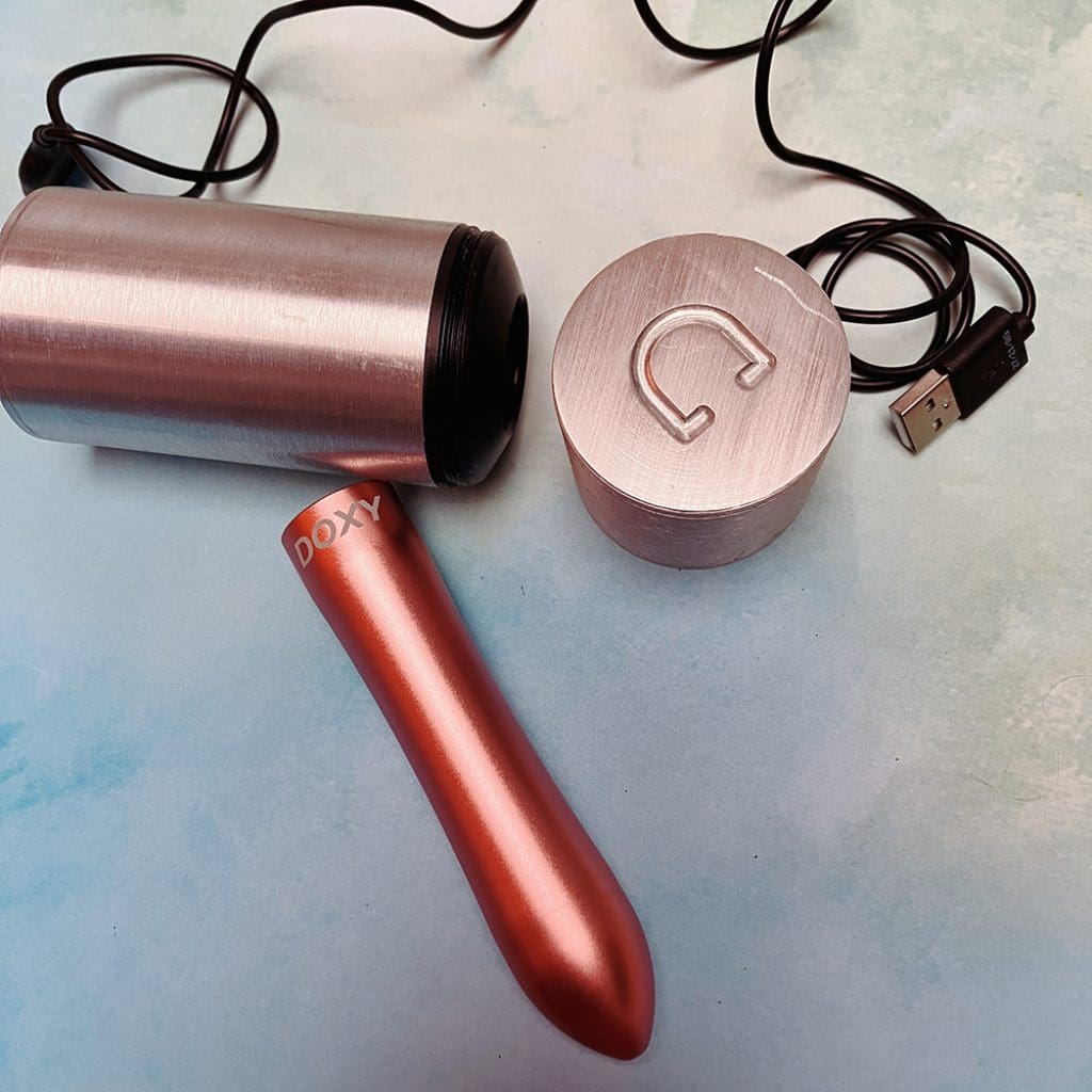 rose gold bullet vibe, metal tube storage case, black USB charging cord