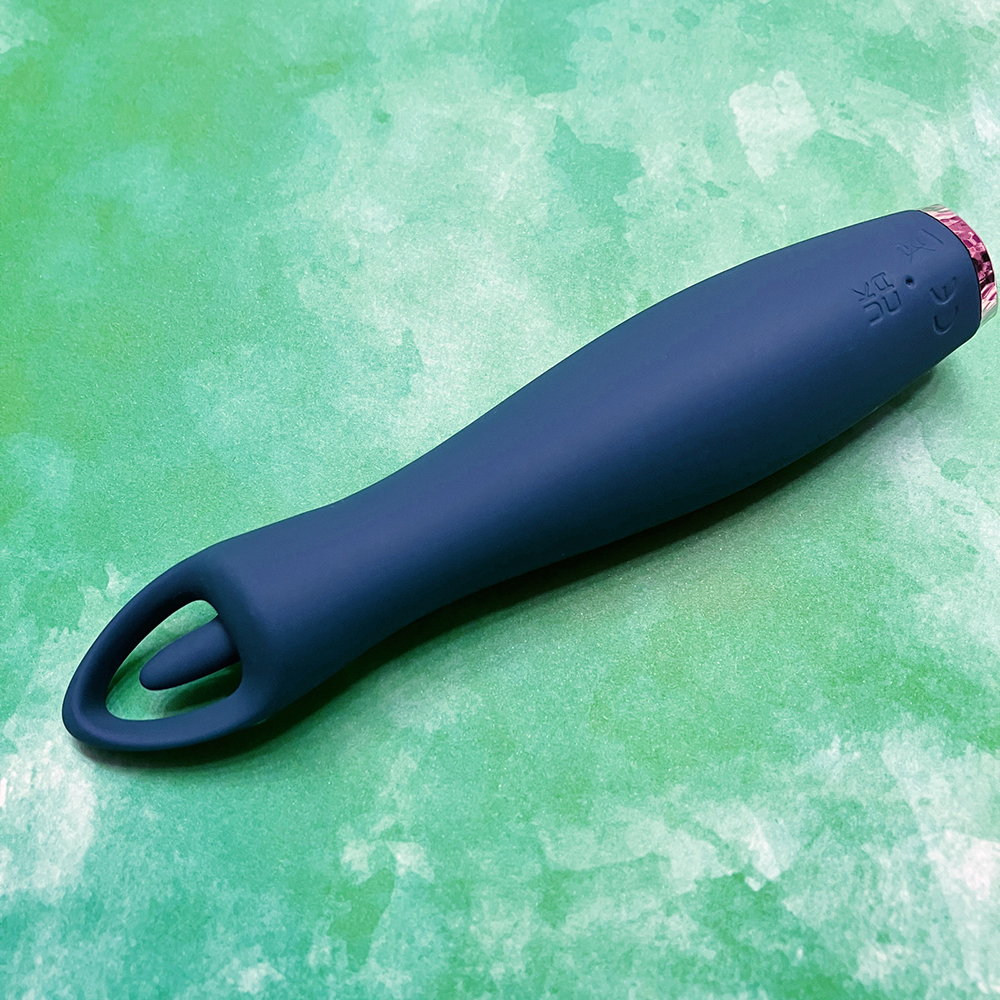 photo of underside of toy, showing pin charging port and underside of hoop and flickering nub.