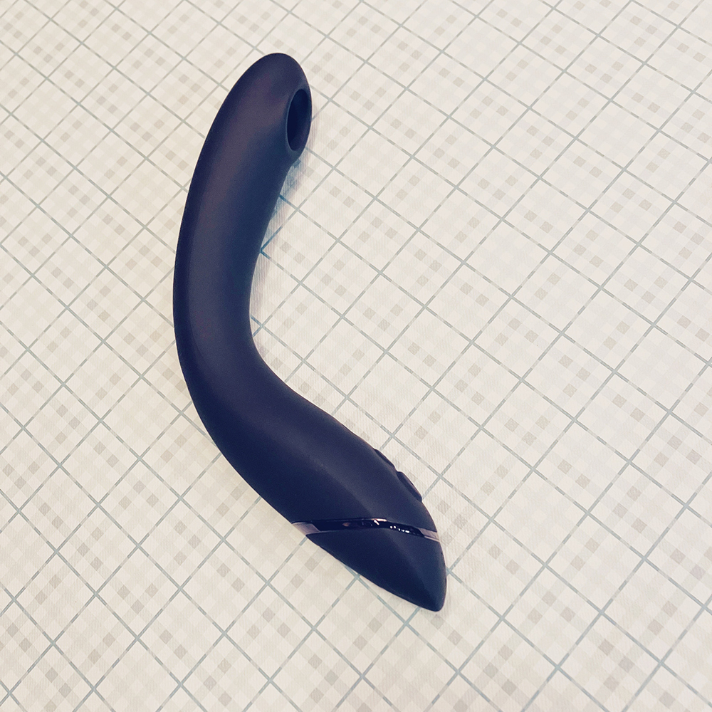 photograph of slate grey insertable air-pulse toy, gently curved in the middle