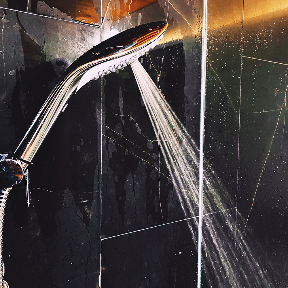 Photograph of chrome shower head showing jet setting
