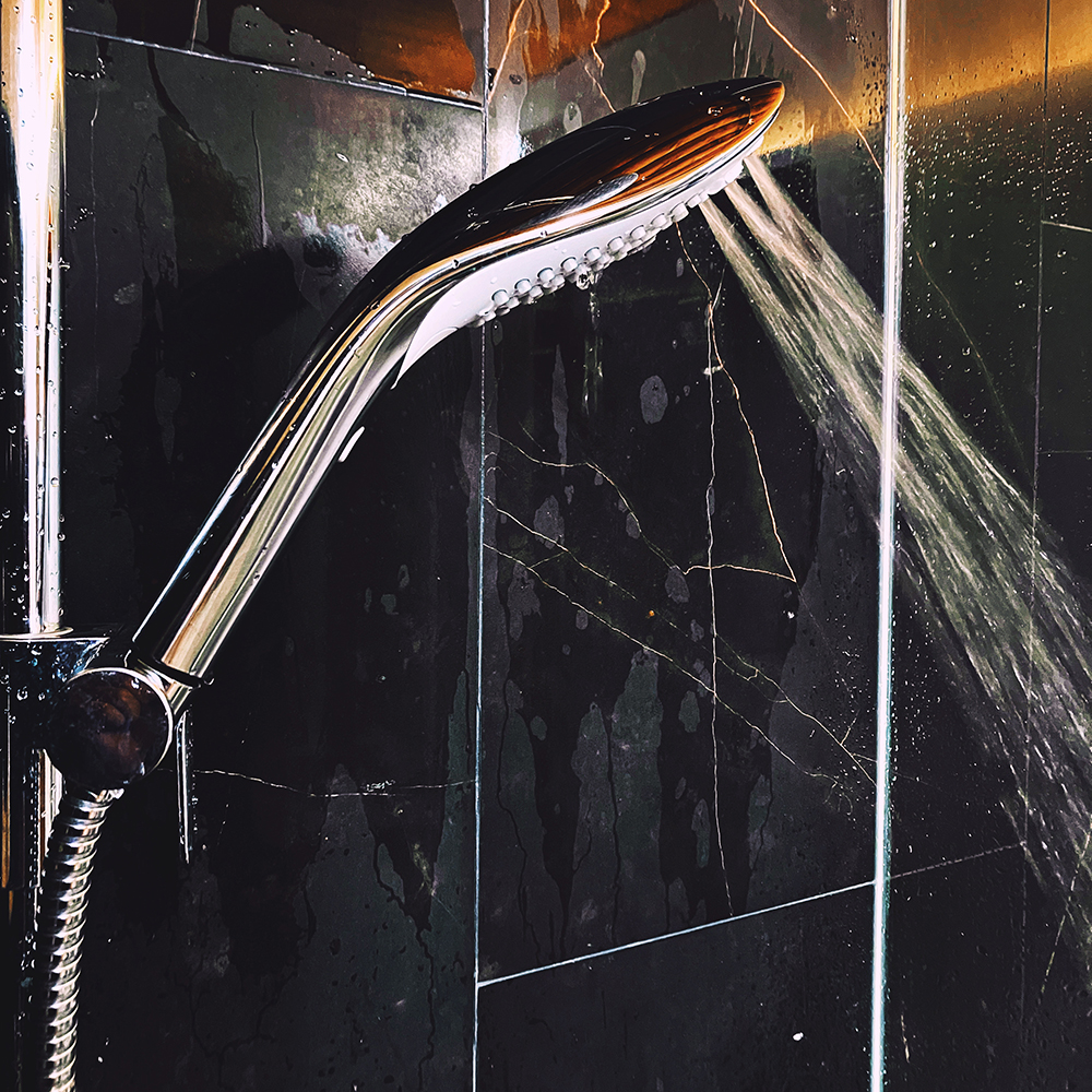 Photograph of chrome shower head on Pleasure Whirl setting